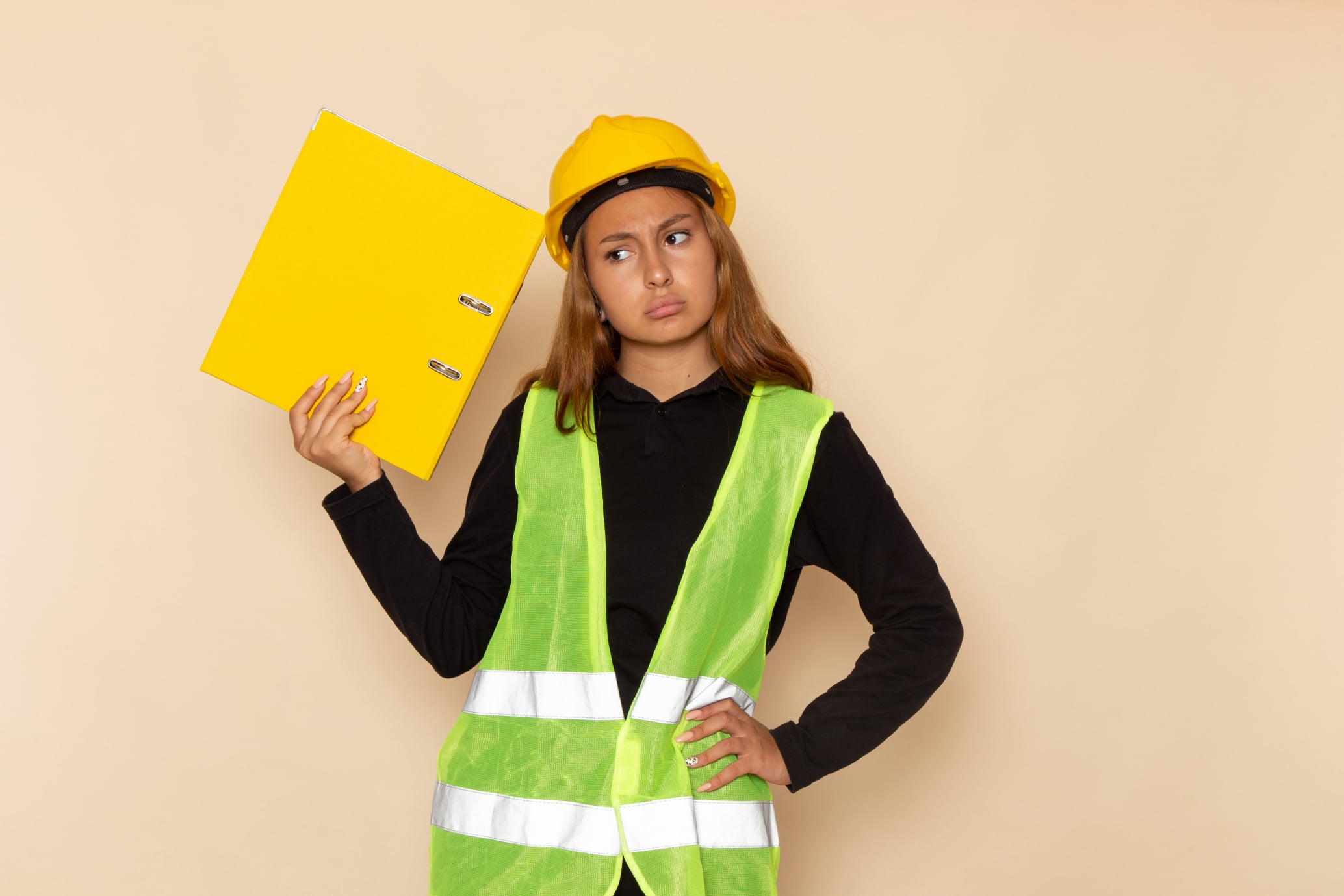 girl in a safety vest holding a safety file